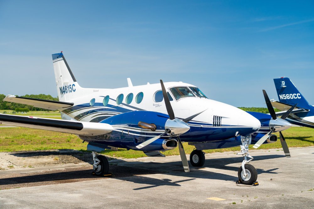 Twin propeller charter plane on sunny tarmac