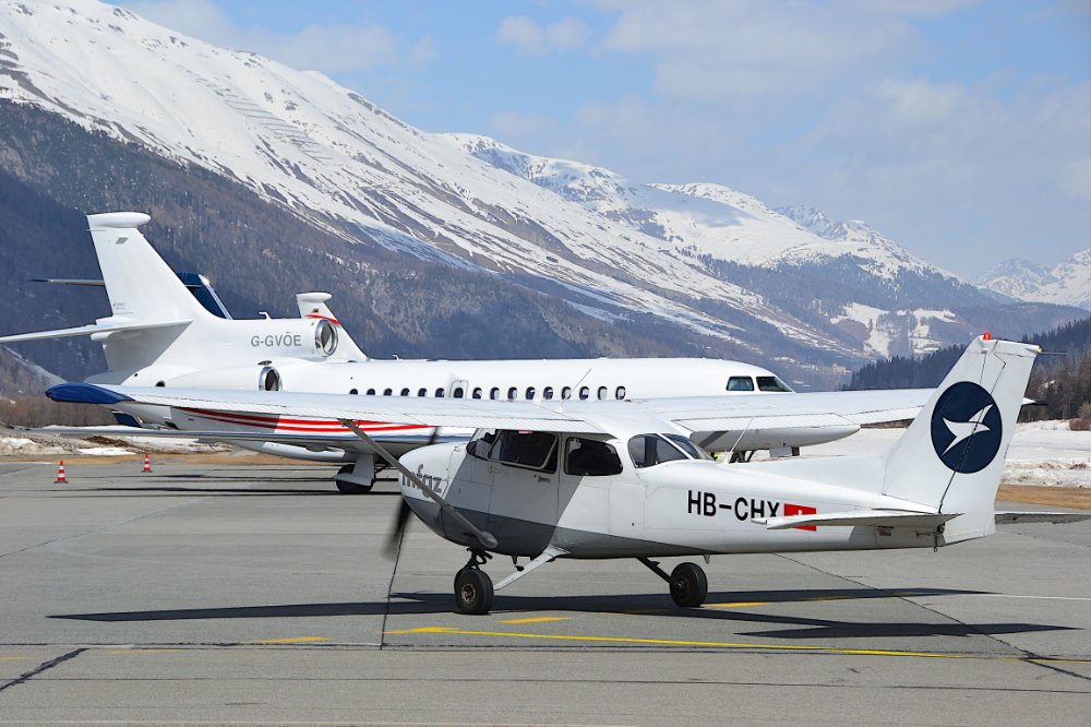 Private jet on runway with mountain backdrop